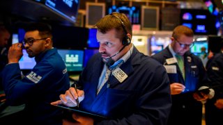 Traders work during the opening bell at the New York Stock Exchange (NYSE) on February 27, 2020 at Wall Street in New York City.