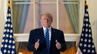 President Donald Trump gives thumbs up on the Blue Room Balcony upon returning to the White House Monday, Oct. 5, 2020, in Washington, after leaving Walter Reed National Military Medical Center, in Bethesda, Md.