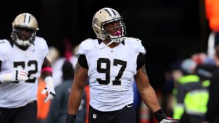 Defensive end Glenn Foster #97 of the New Orleans Saints takes the field before the start of the Saints and New England Patriots game at Gillette Stadium on October 13, 2013, in Foxboro, Massachusetts.