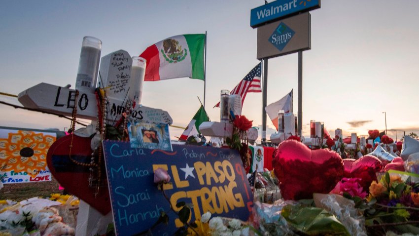 TOPSHOT – People pray and pay their respects at the makeshift memorial for victims of the shooting that left a total of 22 people dead at the Cielo Vista Mall WalMart (background) in El Paso, Texas, on August 6, 2019. – US President Donald Trump on Monday urged Republicans and Democrats to agree on tighter gun control and suggested legislation could be linked to immigration reform after two shootings left 30 people dead and sparked accusations that his rhetoric was part of the problem. “Republicans and Democrats must come together and get strong background checks, perhaps marrying this legislation with desperately needed immigration reform,” Trump tweeted as he prepared to address the nation on two weekend shootings in Texas and Ohio. “We must have something good, if not GREAT, come out of these two tragic events!” Trump wrote. (Photo by Mark RALSTON / AFP) (Photo by MARK RALSTON/AFP via Getty Images)