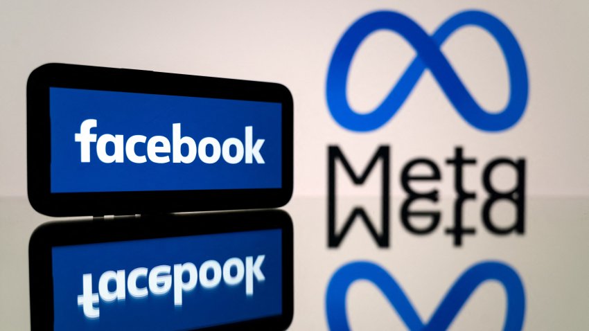 This picture taken on Jan. 12, 2023 in Toulouse, southwestern France shows a smartphone and a computer screen displaying the logos of the social network Facebook and its parent company Meta.