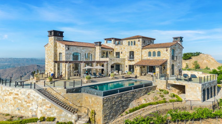 A view of the stone-clad villa’s sundeck and infinity pool.