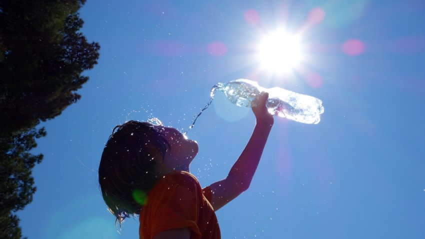 Child pouring water on himself.