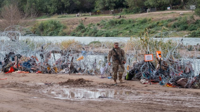 A Texas National Guardsman along the Rio Grande River in Eagle Pass, Texas, US, on Thursday, Oct. 12, 2023. President Biden said he sought to redirect funds to build a border wall but was unsuccessful as his administration announced plans last week to add roughly 17 miles of barriers along the Rio Grande in Texas. Photographer: Jordan Vonderhaar/Bloomberg via Getty Images