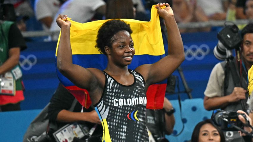 Colombia’s Tatiana Renteria Renteria celebrates with her national flag after beating Ecuador’s Genesis Rosangela Reasco Valdez in their women’s freestyle 76kg wrestling bronze medal match at the Champ-de-Mars Arena during the Paris 2024 Olympic Games, in Paris on August 11, 2024. (Photo by Punit PARANJPE / AFP) (Photo by PUNIT PARANJPE/AFP via Getty Images)