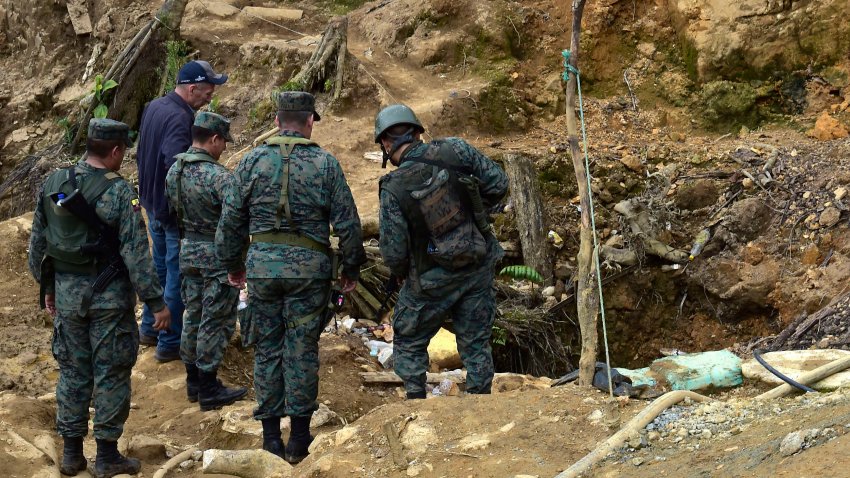 Soldiers and police officers inspect the mining area known as Mina Vieja in the parish of La Merced de Buenos Aires, Ecuador, on July 9, 2019, days after President Lenin Moreno decreed a state of emergency for this resource rich region as part of a crackdown on illegal mining. – On July 1, 2019 Ecuador deployed 2,400 soldiers and police in a remote Andean region after deadly clashes between groups fighting for control of illegal mining activities. Authorities would also investigate crimes such as homicide, sexual exploitation, people trafficking, tax evasion and money laundering, it said. (Photo by Rodrigo BUENDIA / AFP)        (Photo credit should read RODRIGO BUENDIA/AFP via Getty Images)