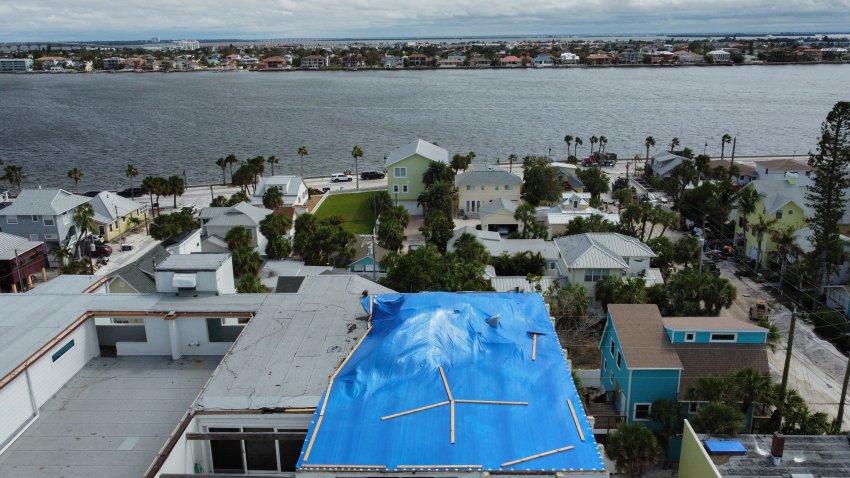 A drone image of a tarp covered apartment complex in the Pass-A-Grille section of St. Petersburg ahead of Hurricane Milton’s expected landfall in the middle of this week on October 7, 2024 in Florida. Florida’s governor has declared a state of emergency on Saturday as forecasters warned that Hurricane Milton is expected to make landfall later this week. (Photo by Bryan R. SMITH / AFP) (Photo by BRYAN R. SMITH/AFP via Getty Images)