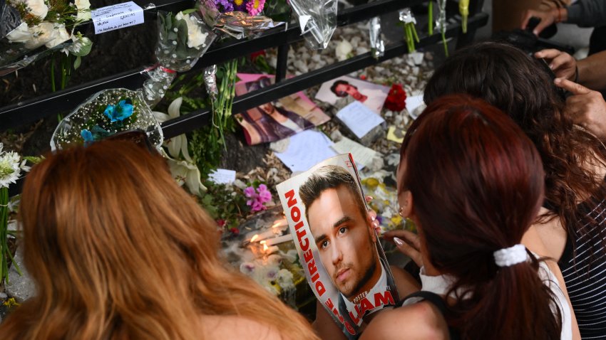 Fans pay tribute to British singer Liam Payne in front of the hotel where he died in Buenos Aires on October 17, 2024. Tributes poured in Thursday for British singer Liam Payne, a former member of the best-selling boy band One Direction, after he plunged to his death from the balcony of a Buenos Aires hotel. (Photo by Luis ROBAYO / AFP) (Photo by LUIS ROBAYO/AFP via Getty Images)