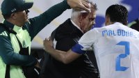 Mexico’s coach, Javier Aguirre (C), is helped by an assistant and Honduras’ defender #02 Denil Maldonado after being injured in the head when he was hit by an object thrown from the bleachers at the end of the National League of Concacaf quarterfinal first leg match between Honduras and Mexico at the Francisco Morazan stadium in San Pedro Sula, Honduras, on November 15, 2024. (Photo by Jhony MAGALLANES / AFP) (Photo by JHONY MAGALLANES/AFP via Getty Images)