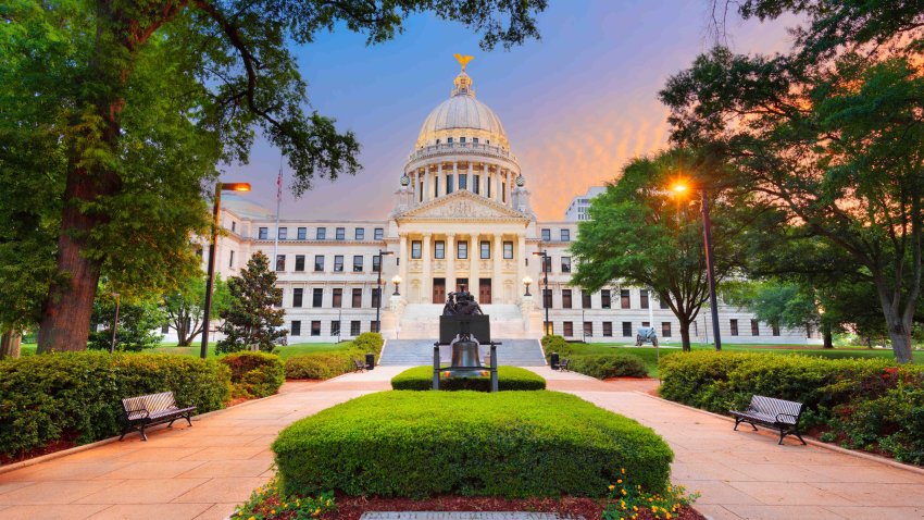 JACKSON, MISSISSIPPI – MAY 25, 2016: Mississippi State Capitol at twilight with the Monument to Women of the Confederacy dating from 1917.