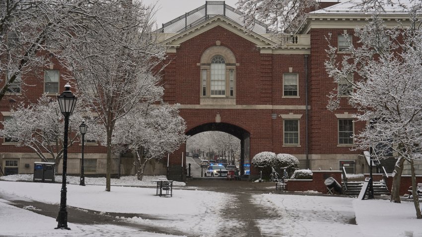A Providence Police Department vehicle is seen through the gate at the Stephen Robert Campus Center at Brown University, in Providence, Rhode Island on December 14, 2025. Hundreds of police officers hunted Sunday for a gunman who killed two people and wounded nine others at Brown University, plunging the eastern US campus into lockdown. (Photo by Bing Guan / AFP via Getty Images)