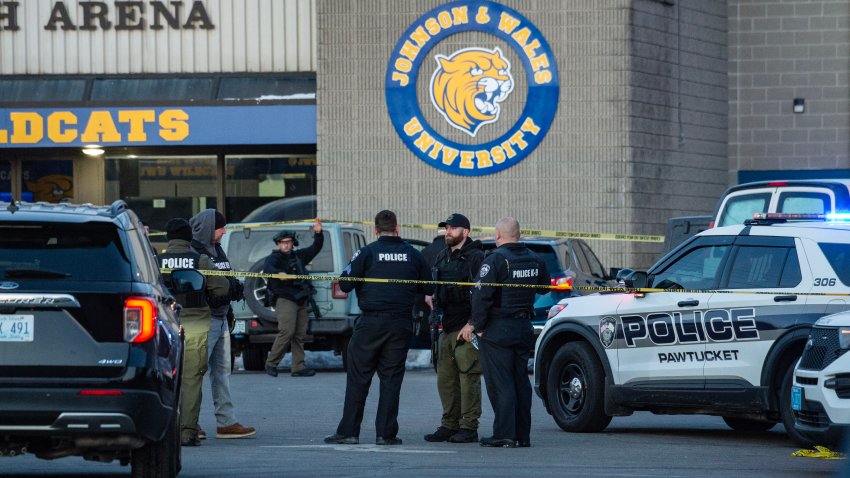 Police stand outside the perimeter they created around the Dennis M. Lynch Arena where a shooting occurred earlier today in Pawtucket, Rhode Island, on February 16, 2026. At least two people were killed and three wounded in a shooting at an ice rink in the northeastern US town of Pawtucket on Monday, authorities said, with social media footage showing frightened teenagers fleeing the sound of gunshots. "We have three deceased. The suspect, and then we have two victims, and then we have three at the hospital," said Pawtucket police chief Tina Goncalves told reporters after the incident. She added that initial investigations suggested the shooting was targeted and "may be a family dispute." (Photo by Joseph Prezioso / AFP via Getty Images)