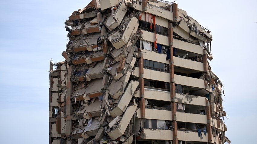 TOPSHOT – A view shows a heavily damaged apartment building following an earthquake in Catia La Mar, La Guaira state, about 30 km northwest of Caracas, on June 25, 2026. A twin earthquake that was Venezuela’s largest in over a century has killed at least 164 people and destroyed multiple buildings near the capital, where residents searched on June 25 for missing relatives. (Photo by Juan BARRETO / AFP via Getty Images)